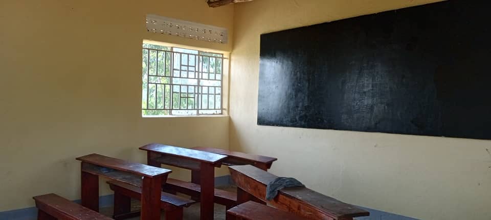 Finished classroom with desks facing a new blackboard