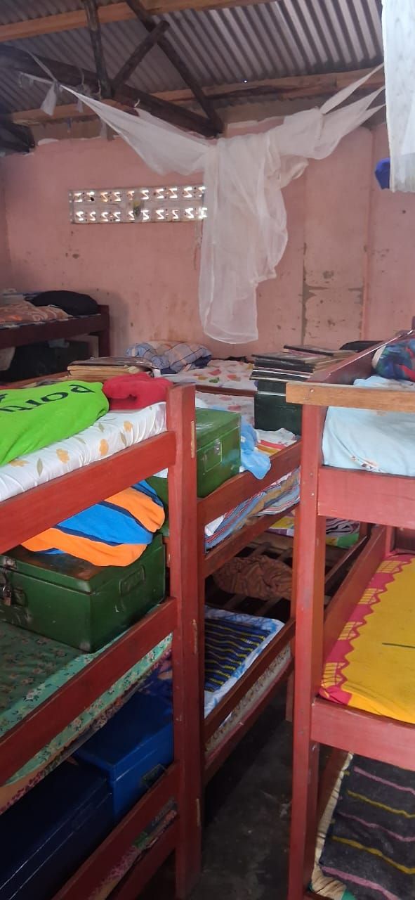 Bunk beds and personal belongings inside a St. Mary's dormitory
