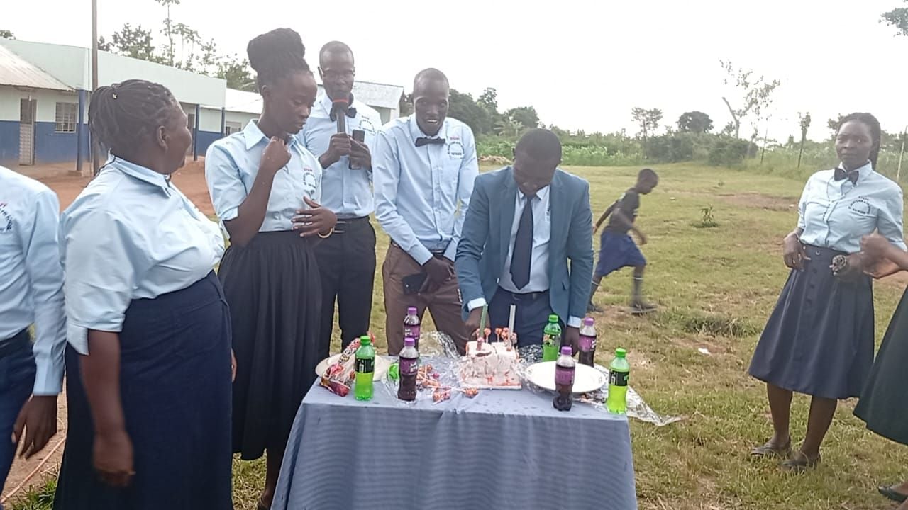 Staff celebrating a special occasion on the school field