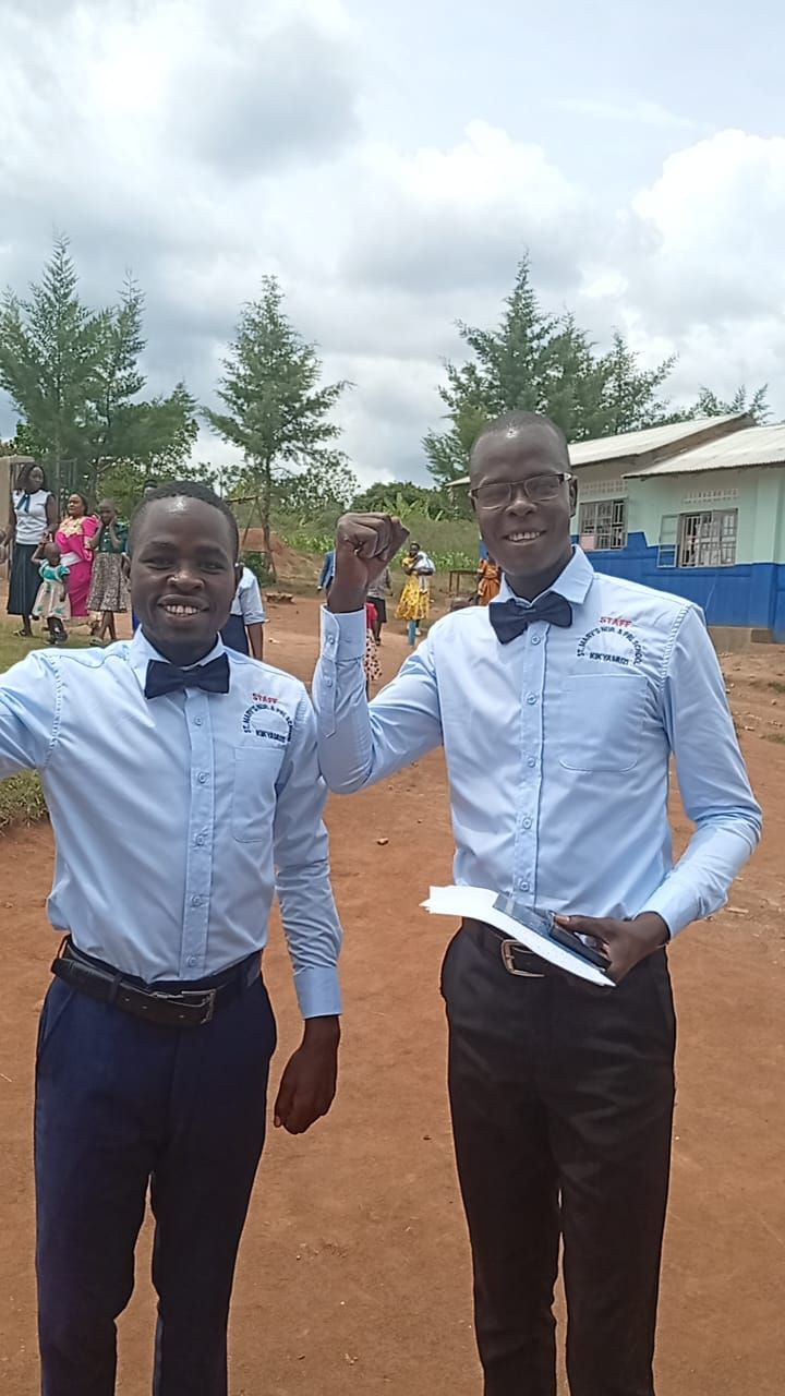 Two St. Mary's staff members near the school