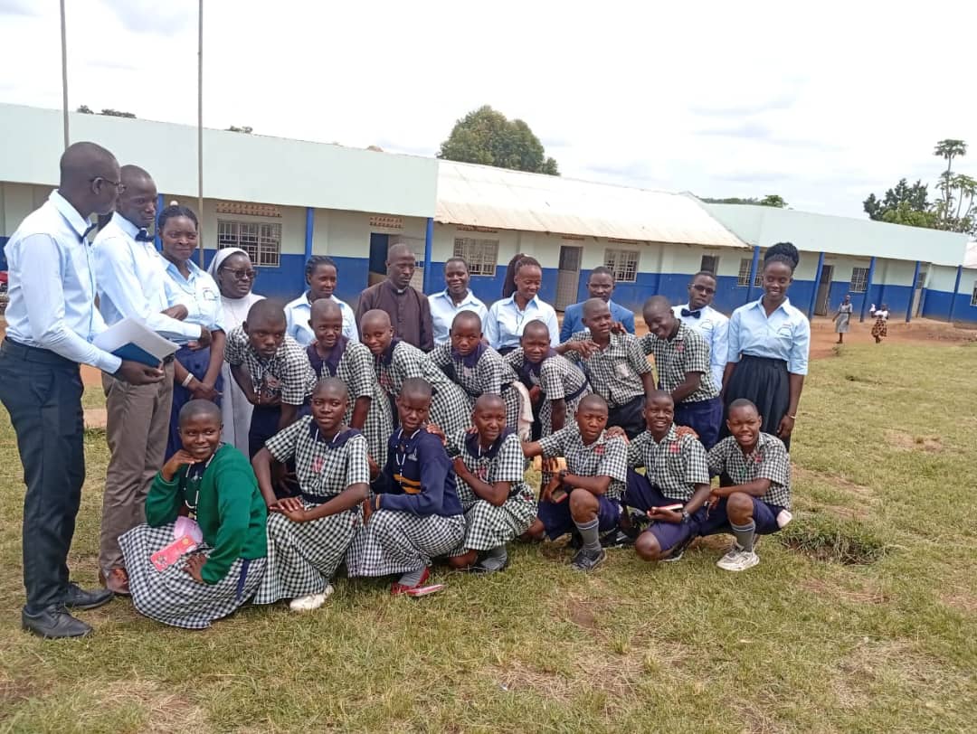 Fr. Emmanuel, Sisters, staff and pupils in front of the St. Mary's school building