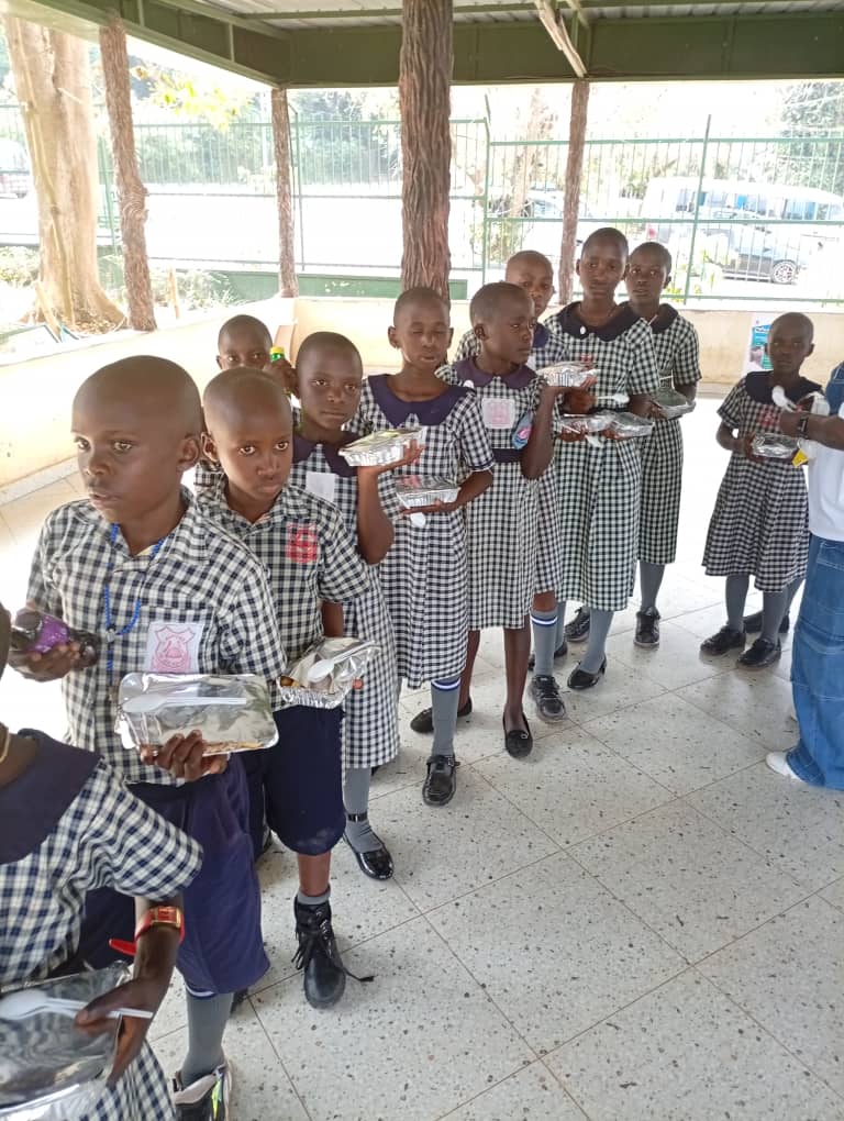 Pupils learning about recycled crafts made from bottle caps