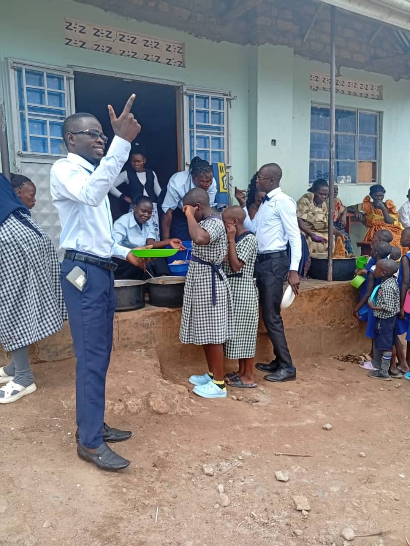 A staff member serving a meal to pupils at St. Mary's