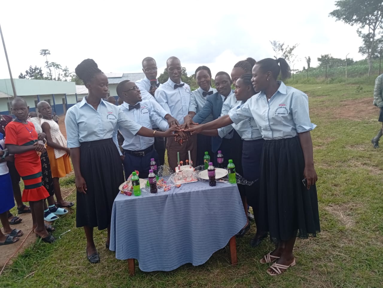 St. Mary's staff celebrating together in front of the school building