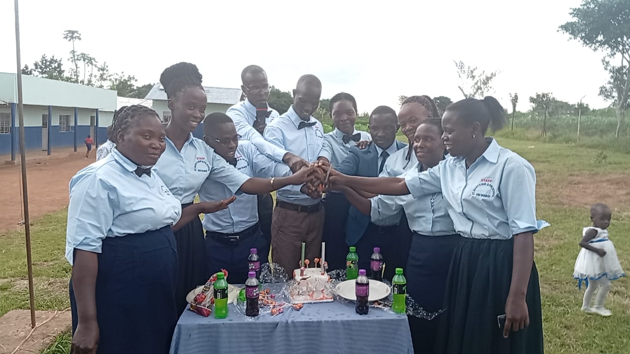St. Mary's staff celebrating together in front of the school building
