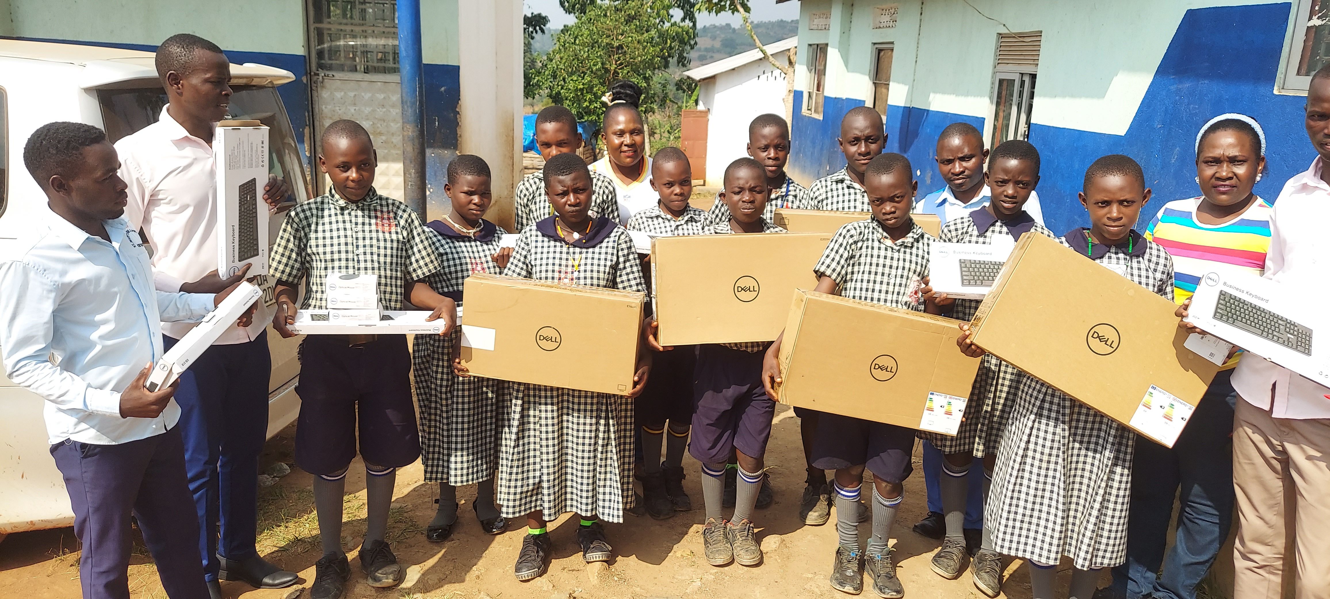 St. Mary's pupils and staff receiving donated Dell computers and keyboards