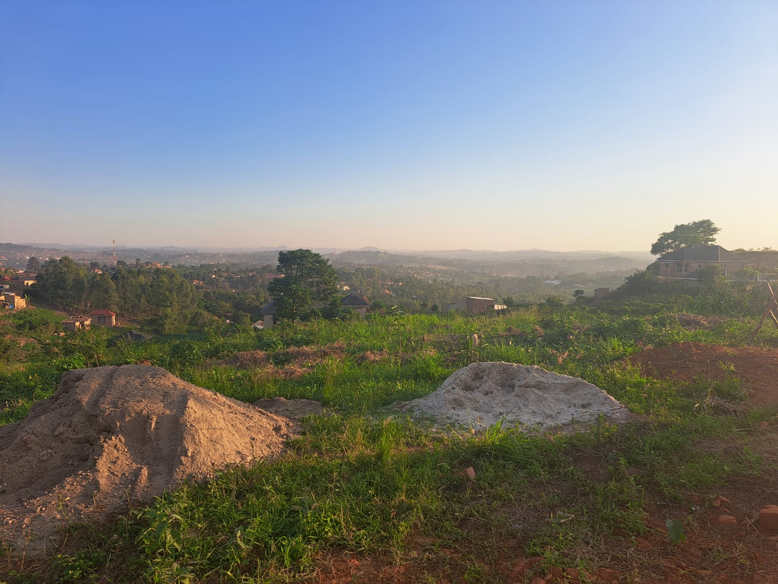 View across the hills from the St. Mary's land in Mbugu Village, with sand piled for building