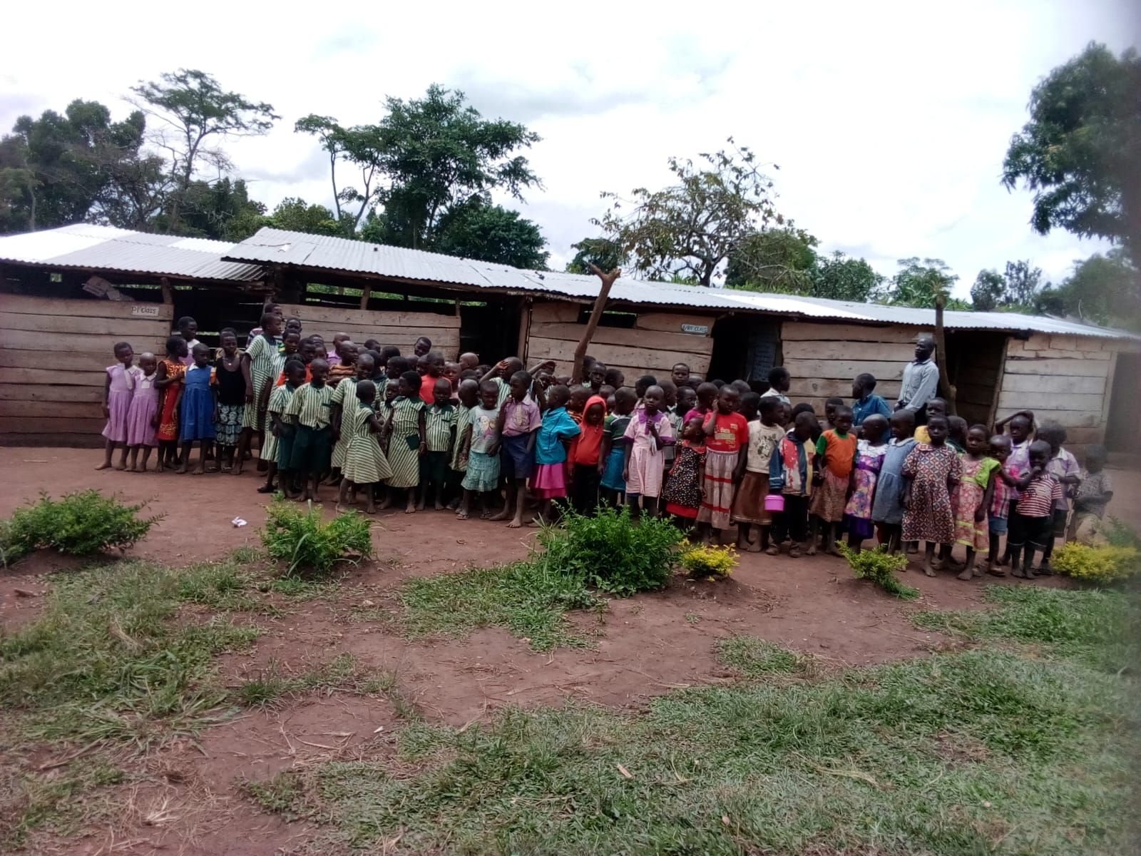 Pupils lined up outside St. Mary's original wooden classroom block in 2018